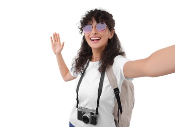 Photo of Beautiful woman in sunglasses with camera taking selfie on white background