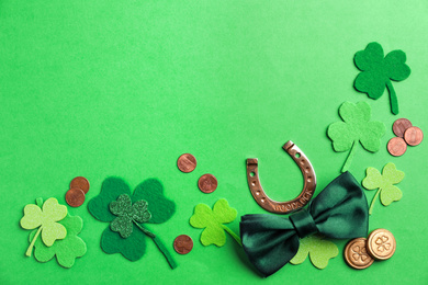 Flat lay composition with horseshoe on green background, space for text. St. Patrick's Day celebration