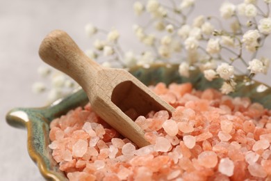 Orange sea salt and beautiful flowers, closeup