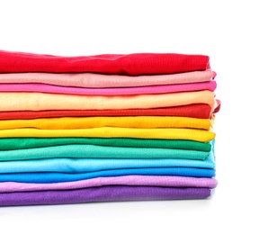 Photo of Stack of colorful t-shirts on white background