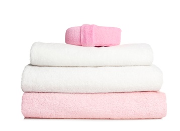 Folded soft terry towels and sponge on white background