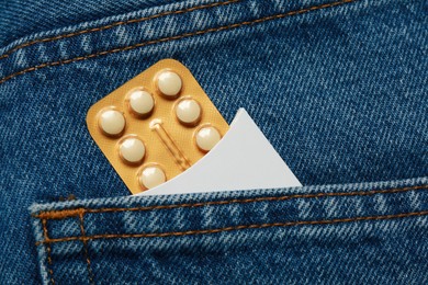 Birth control pills in pocket of jeans, closeup