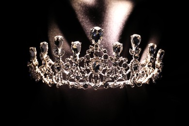 Photo of Beautiful silver tiara with diamonds on black cloth