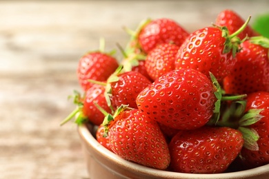 Photo of Bowl with fresh ripe strawberries on table, closeup