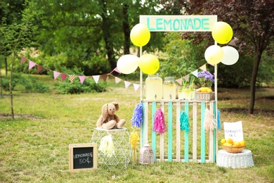 Photo of Decorated lemonade stand with glassware in park