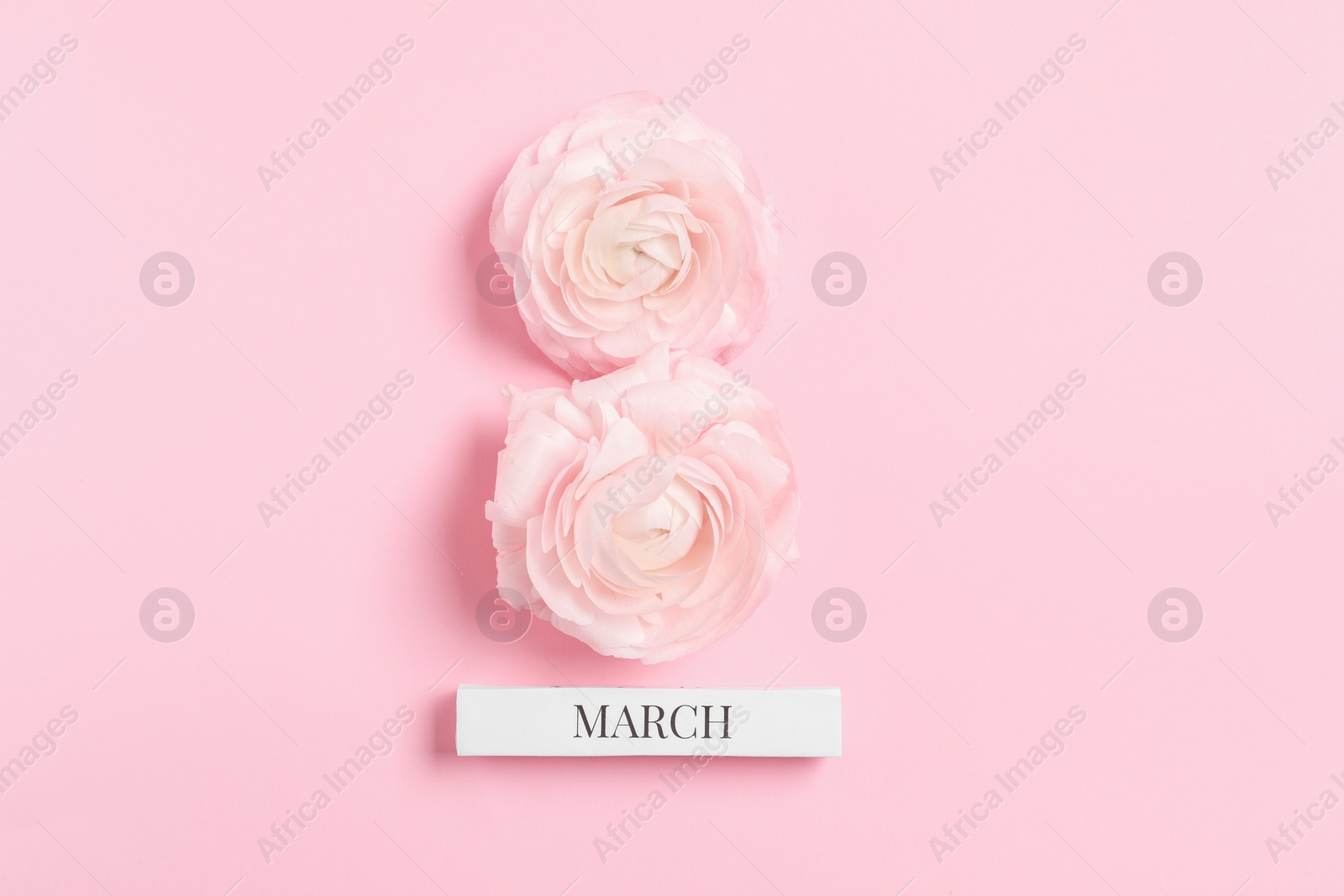 Photo of International Women's day. 8th of March made with beautiful flowers on light pink background, top view