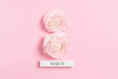 Photo of International Women's day. 8th of March made with beautiful flowers on light pink background, top view