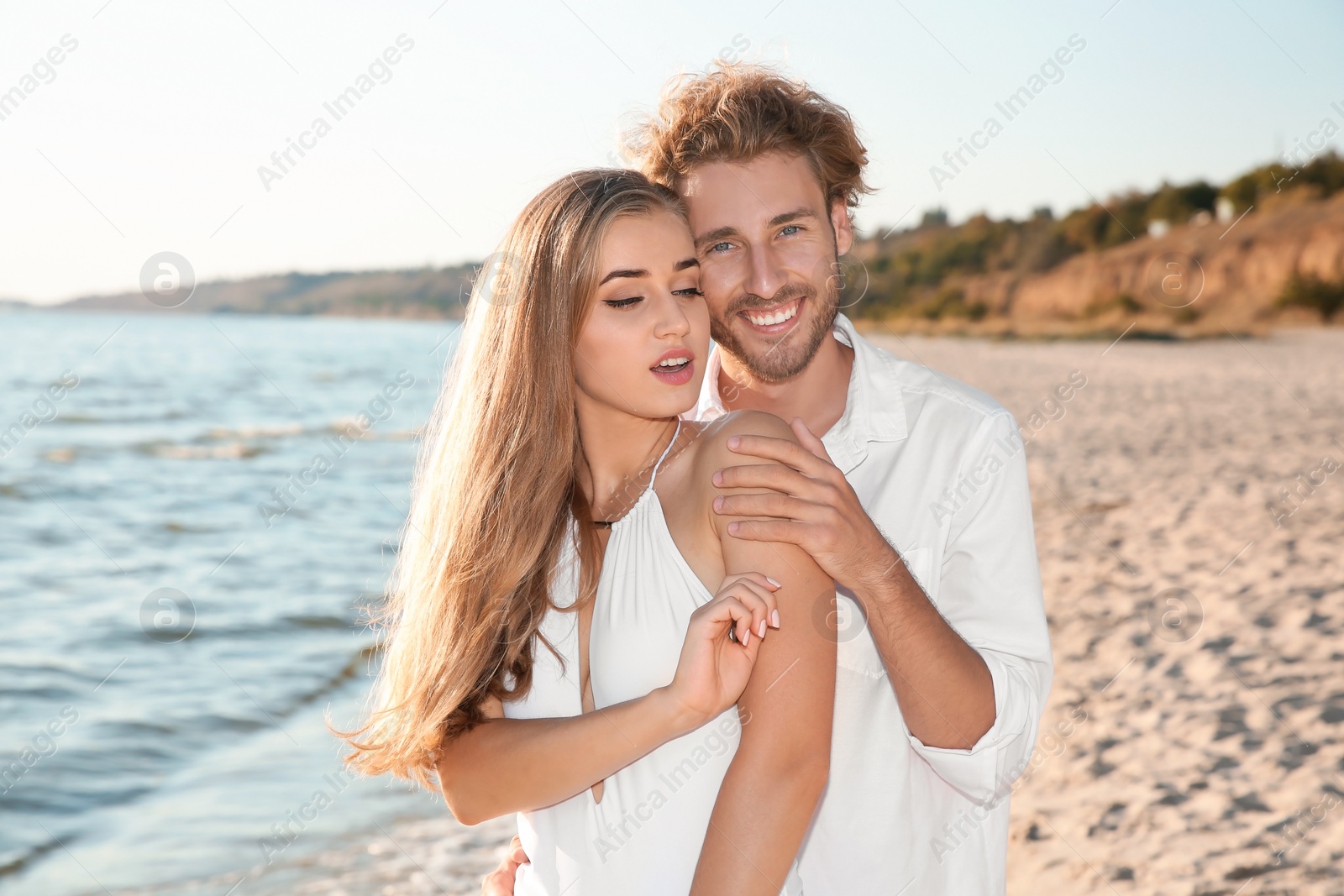 Photo of Romantic young couple spending time together on beach