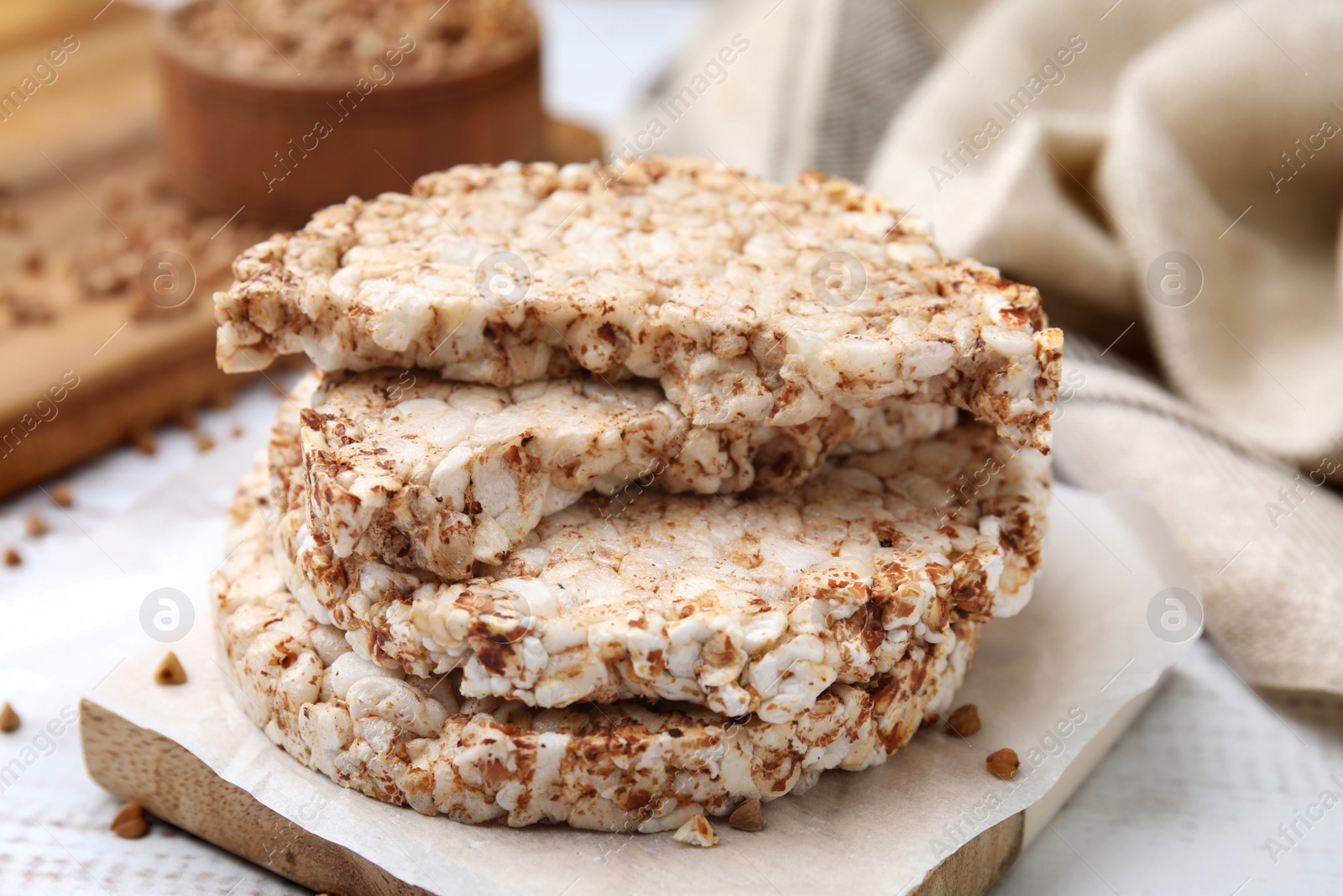 Photo of Stack of crunchy buckwheat cakes on wooden table, closeup