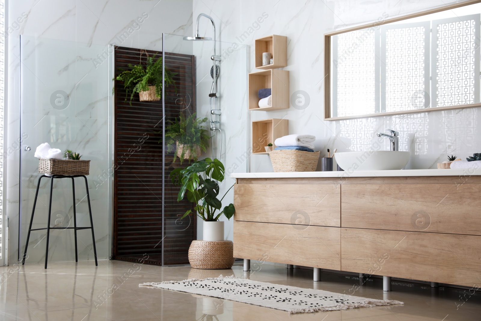 Photo of Bathroom interior with shower stall, counter and houseplants. Idea for design