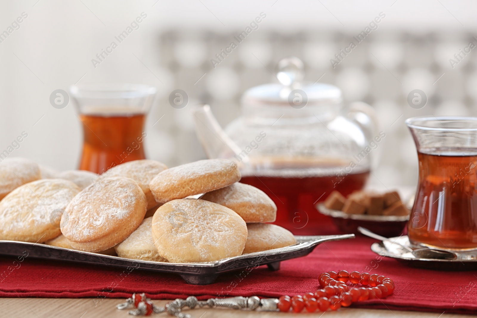 Photo of Traditional Islamic cookies and tea on table, space for text. Eid Mubarak