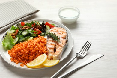 Photo of Plate with healthy food high in vegetable fats served on light wooden table, closeup