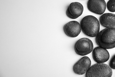 Photo of Wet zen stones on white background, top view with space for text