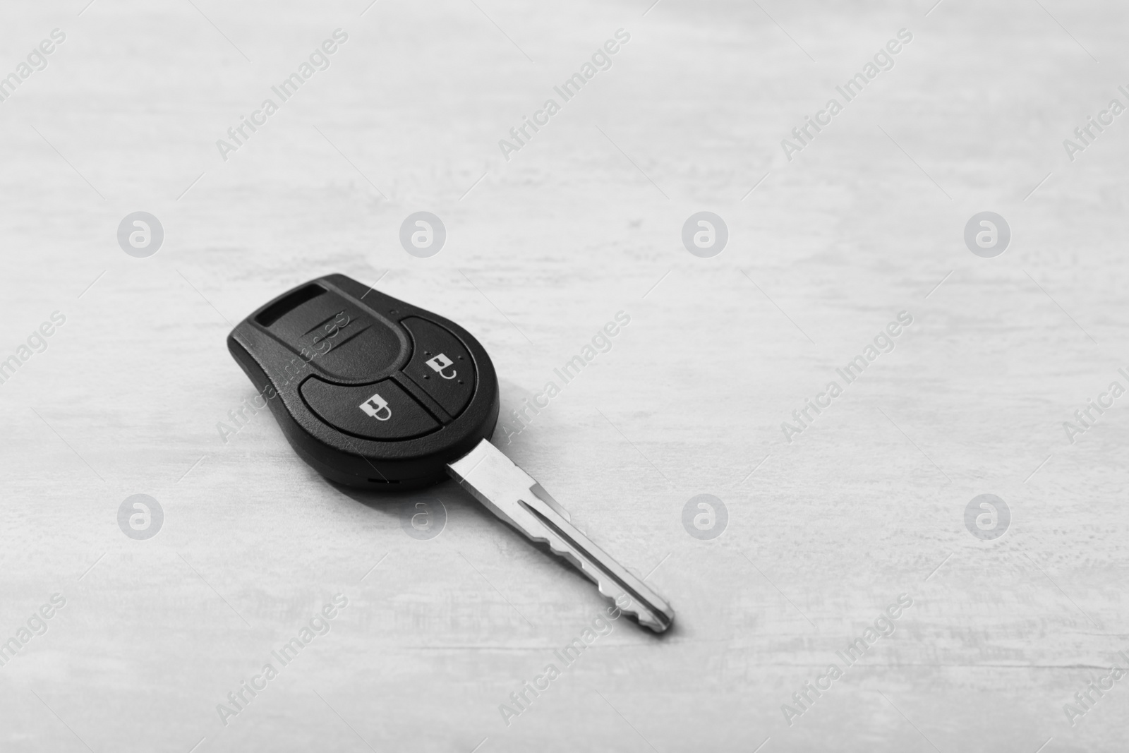 Photo of Car key on light background. Space for text