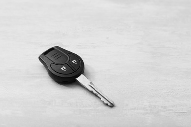 Photo of Car key on light background. Space for text