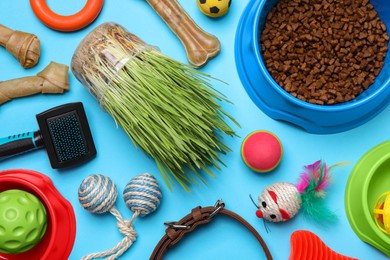 Flat lay composition with pet toys, food and accessories on light blue background