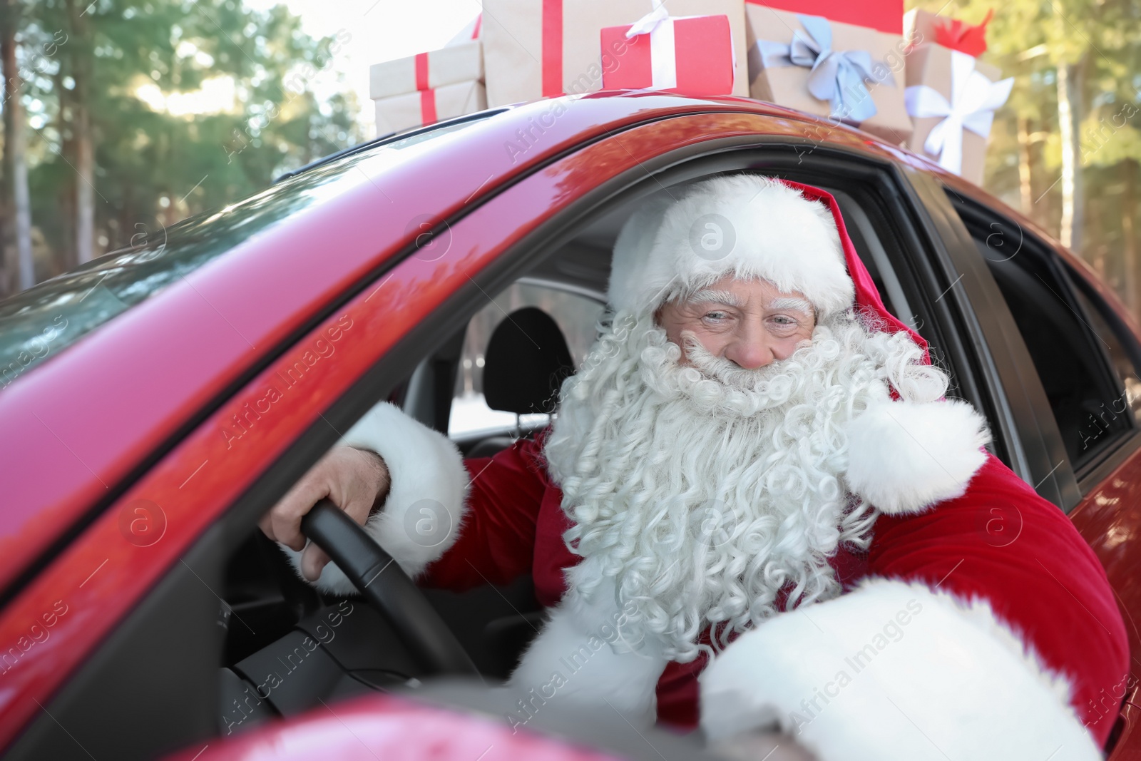 Photo of Authentic Santa Claus in red car, view from outside