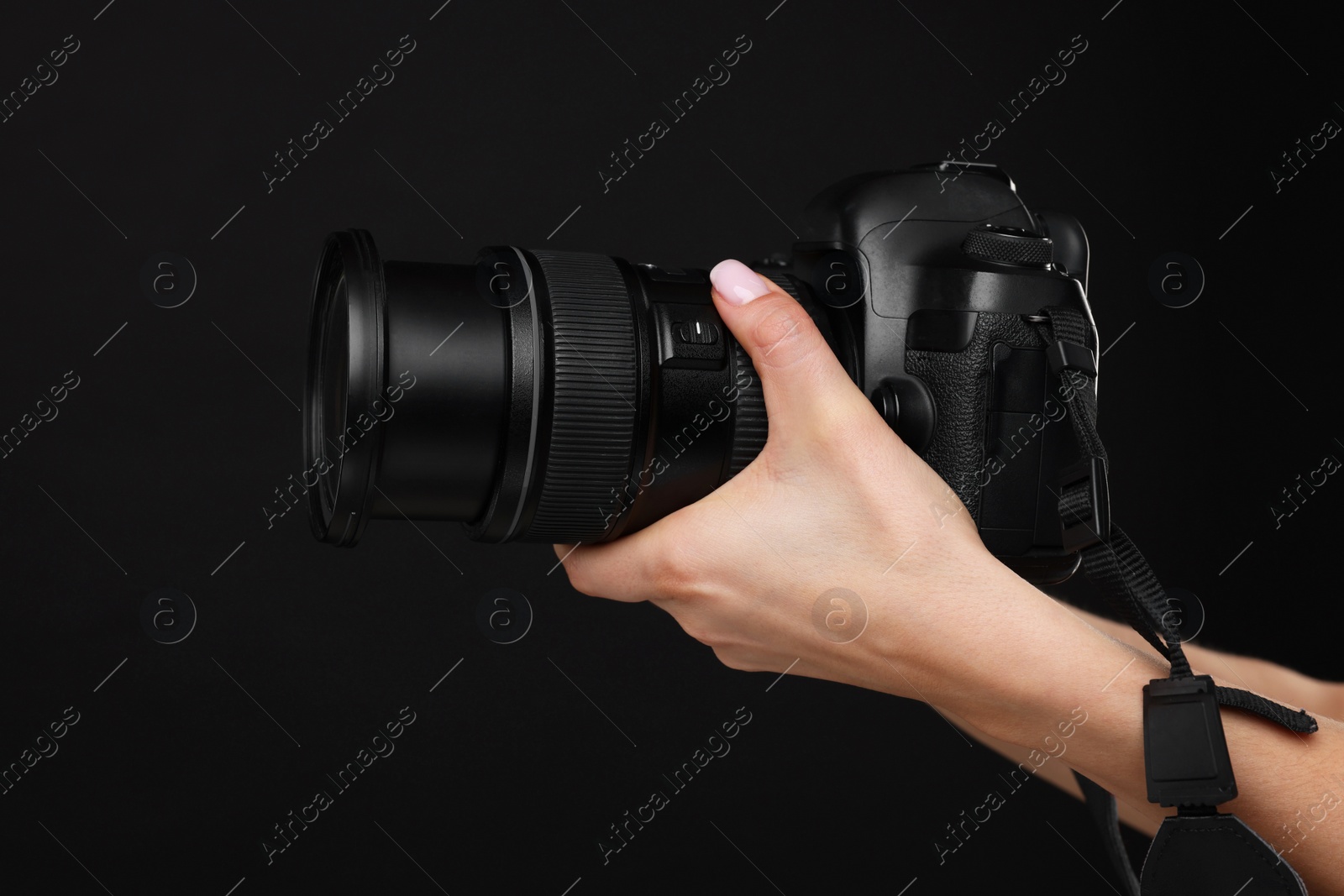 Photo of Photographer with camera on black background, closeup