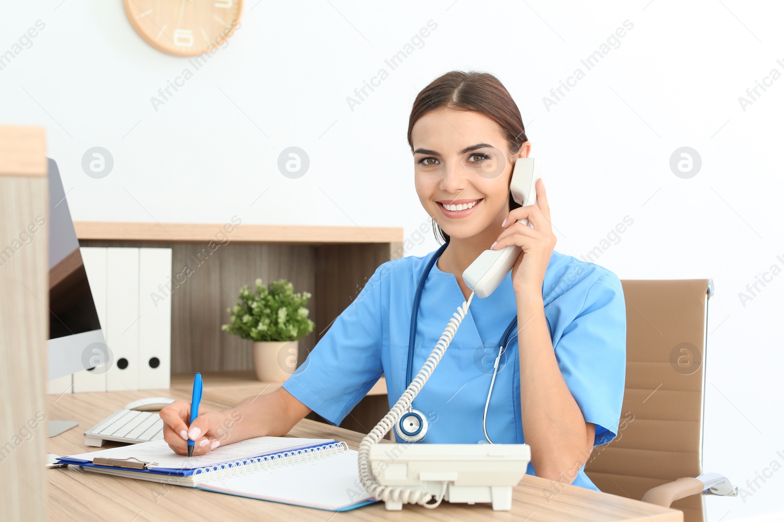 Photo of Female medical assistant at workplace in clinic. Health care service