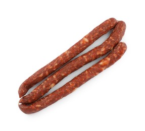 Photo of Thin dry smoked sausages isolated on white, top view