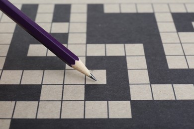 Pencil and blank crossword, closeup. Space for text