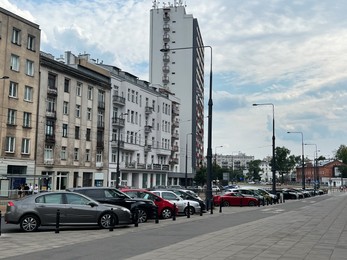 Photo of Different modern cars parked on city street