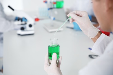 Photo of Medical student working in modern scientific laboratory, closeup