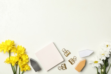 Photo of Stationery and flowers on white background, flat lay with space for text. Teacher's Day