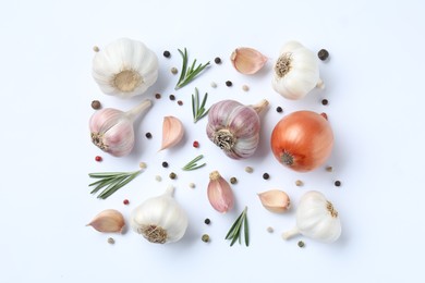 Photo of Fresh garlic, onion, rosemary and peppercorns on white background, flat lay