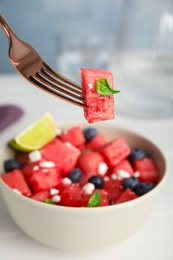 Photo of Delicious salad with watermelon, blueberries and cheese on white table, closeup