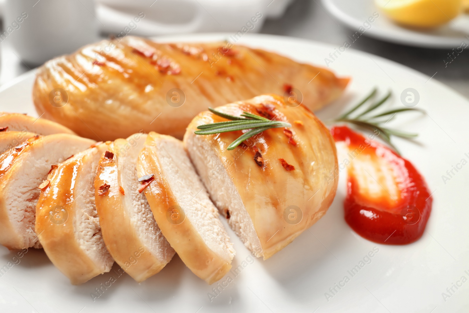 Photo of Fried chicken breast served with sauce on plate, closeup