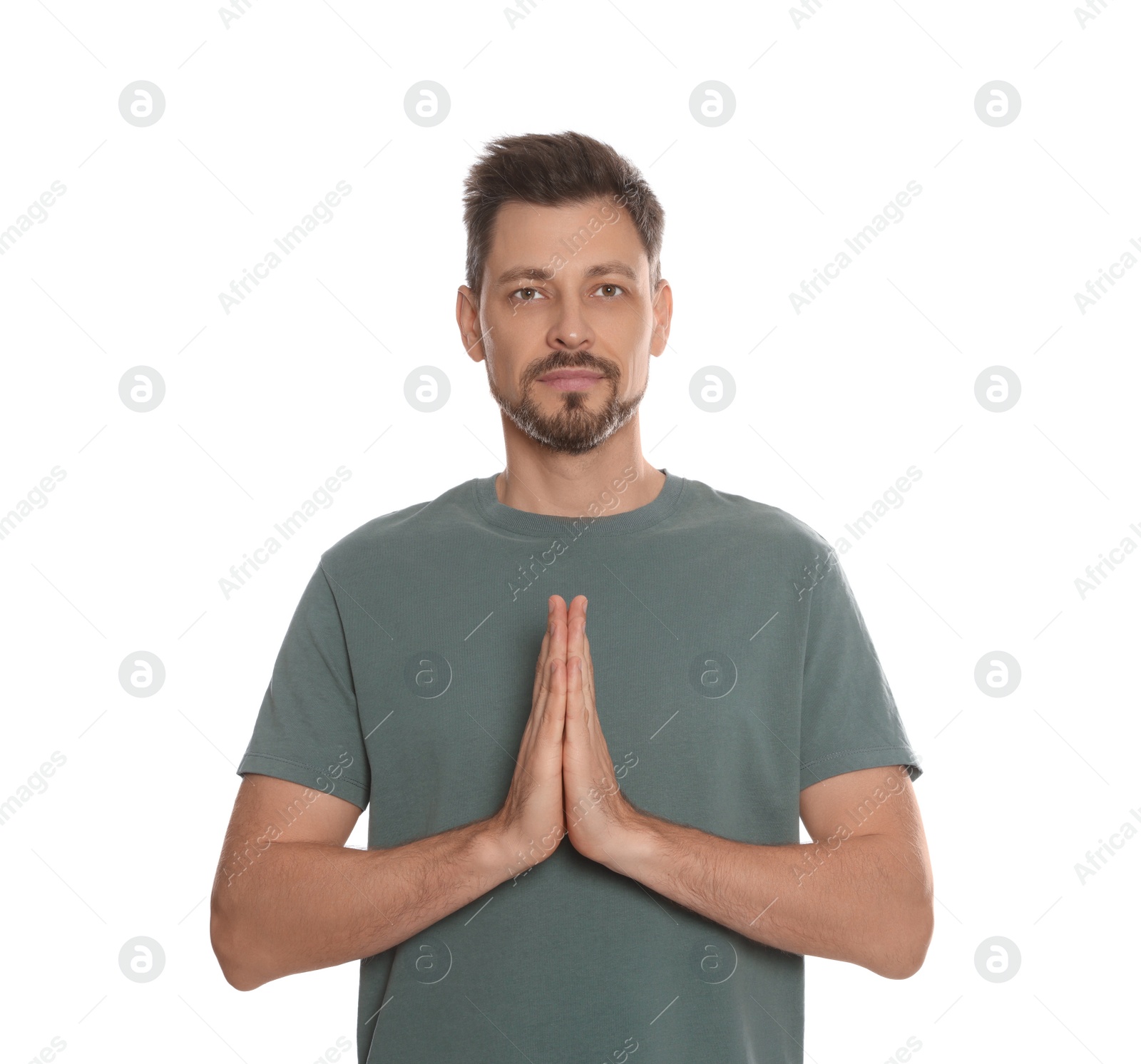 Photo of Man with clasped hands praying on white background