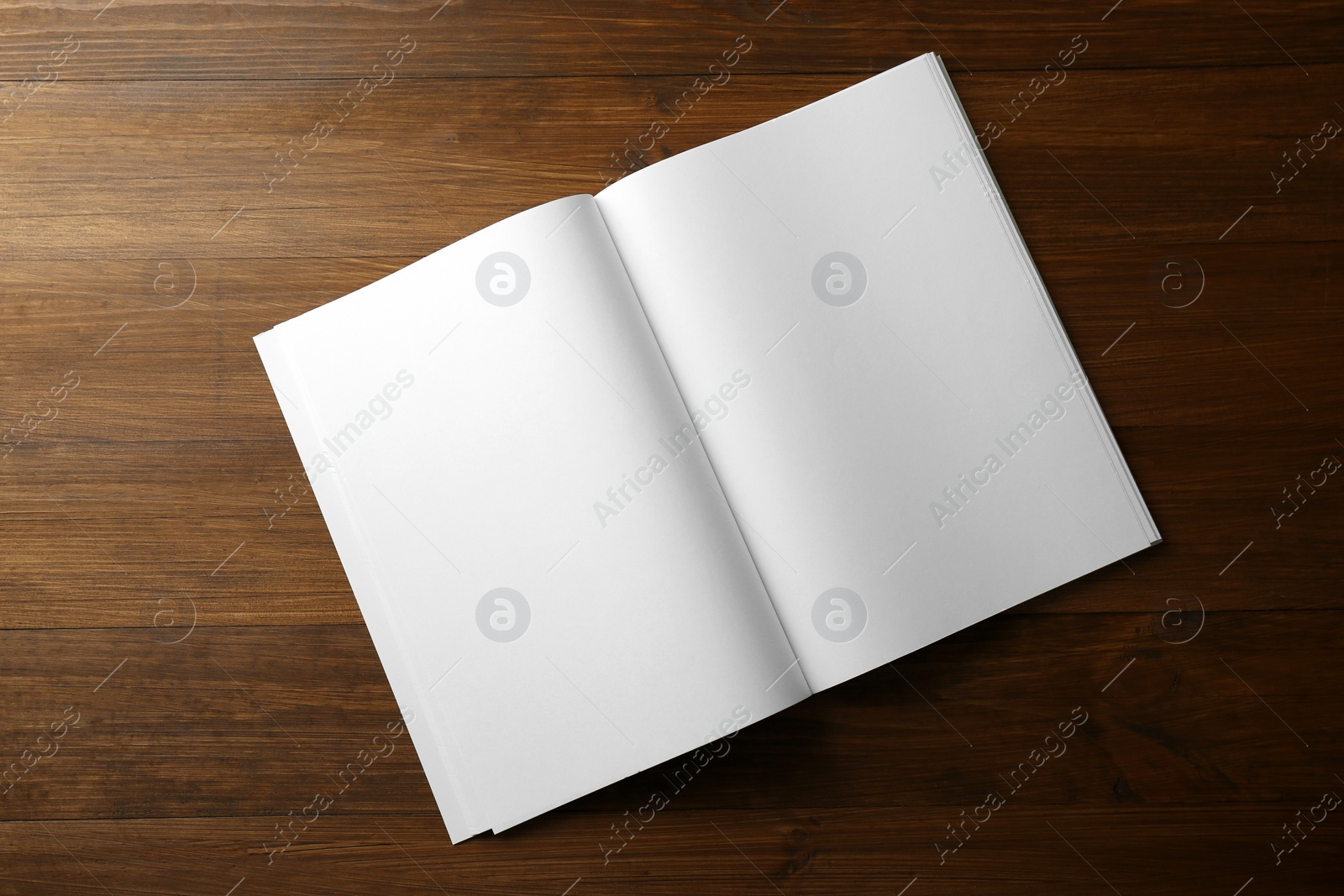 Photo of Open blank paper brochure on wooden table, top view. Mockup for design