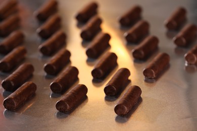 Many delicious chocolate candies on table, closeup. Production line