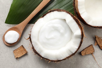 Photo of Ripe coconut and cream on light grey table, flat lay