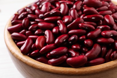 Raw red kidney beans in wooden bowl, closeup