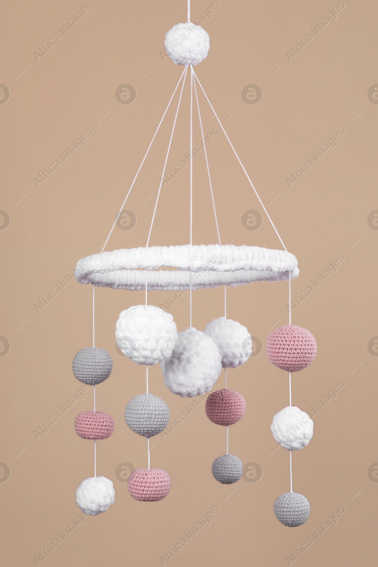 Photo of Cute baby crib mobile on beige background