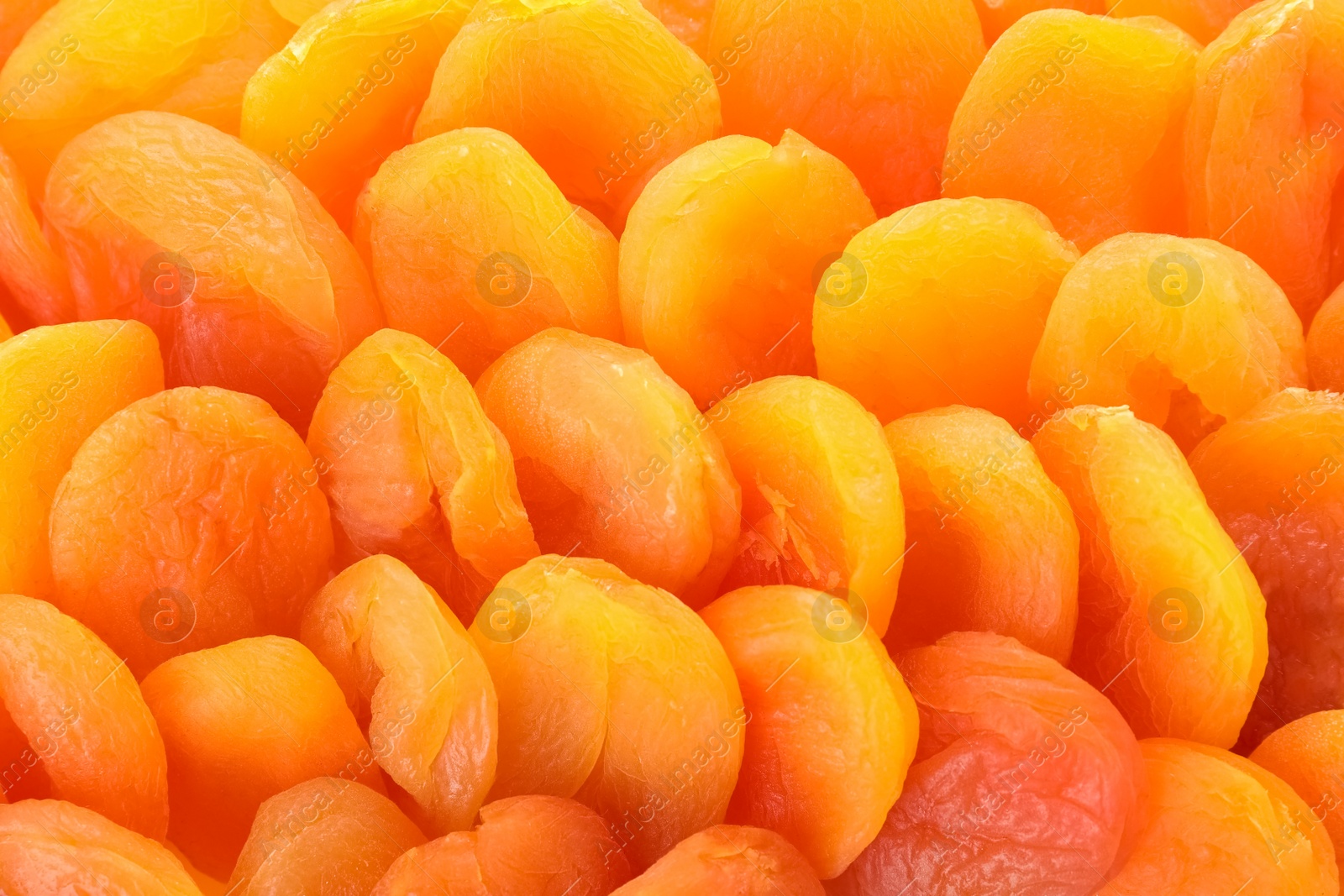 Photo of Tasty apricots as background, closeup. Dried fruit as healthy food