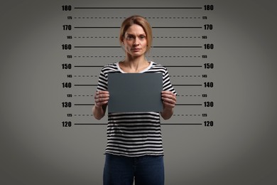 Image of Criminal mugshot. Arrested woman with blank card against height chart