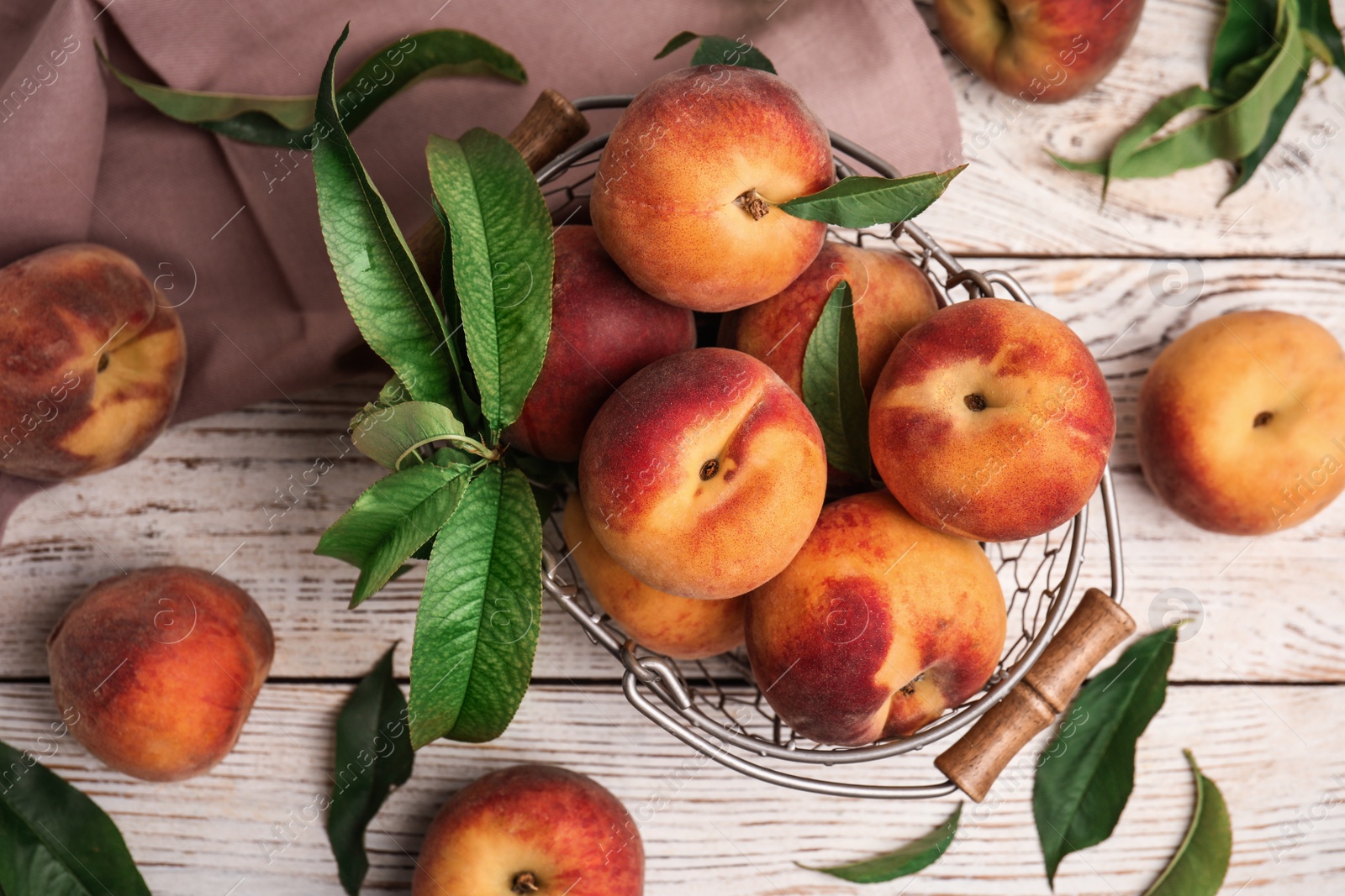 Photo of Fresh ripe juicy peaches on white wooden table, flat lay