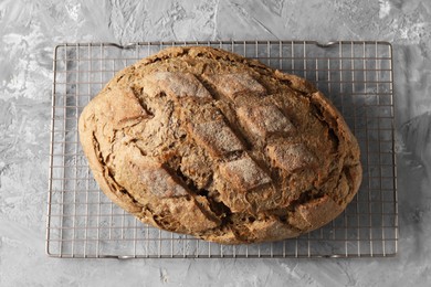 Photo of Freshly baked sourdough bread on grey table, top view