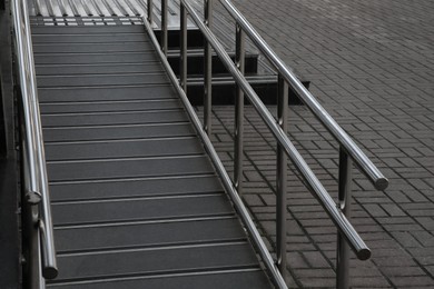 Photo of Ramp with metal railings near building outdoors