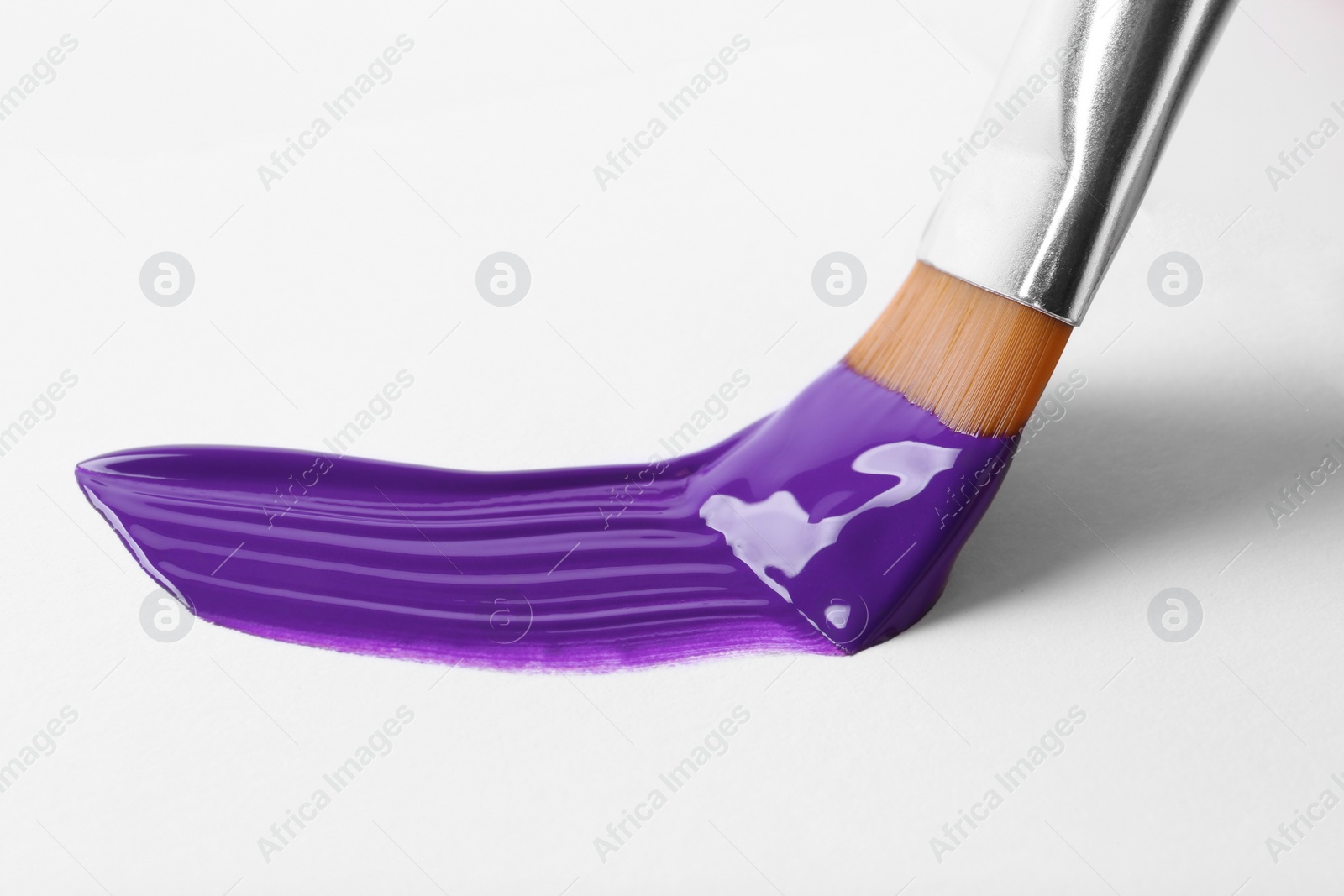 Photo of Brush with color paint and stroke on white background