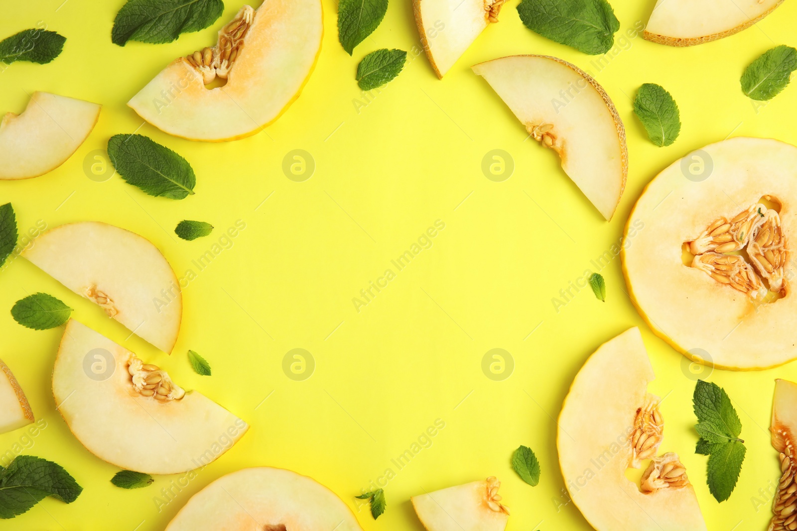 Photo of Frame made of melon and mint leaves with space for text on color background, top view