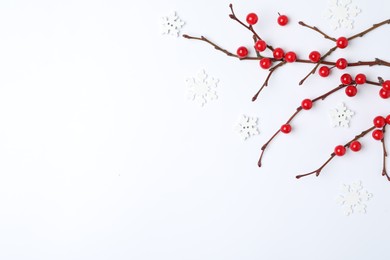 Winter composition with decorative branches on white background, top view