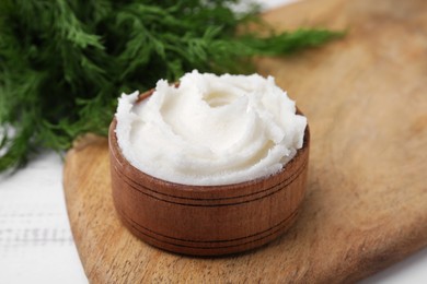 Photo of Delicious pork lard in bowl on wooden board, closeup