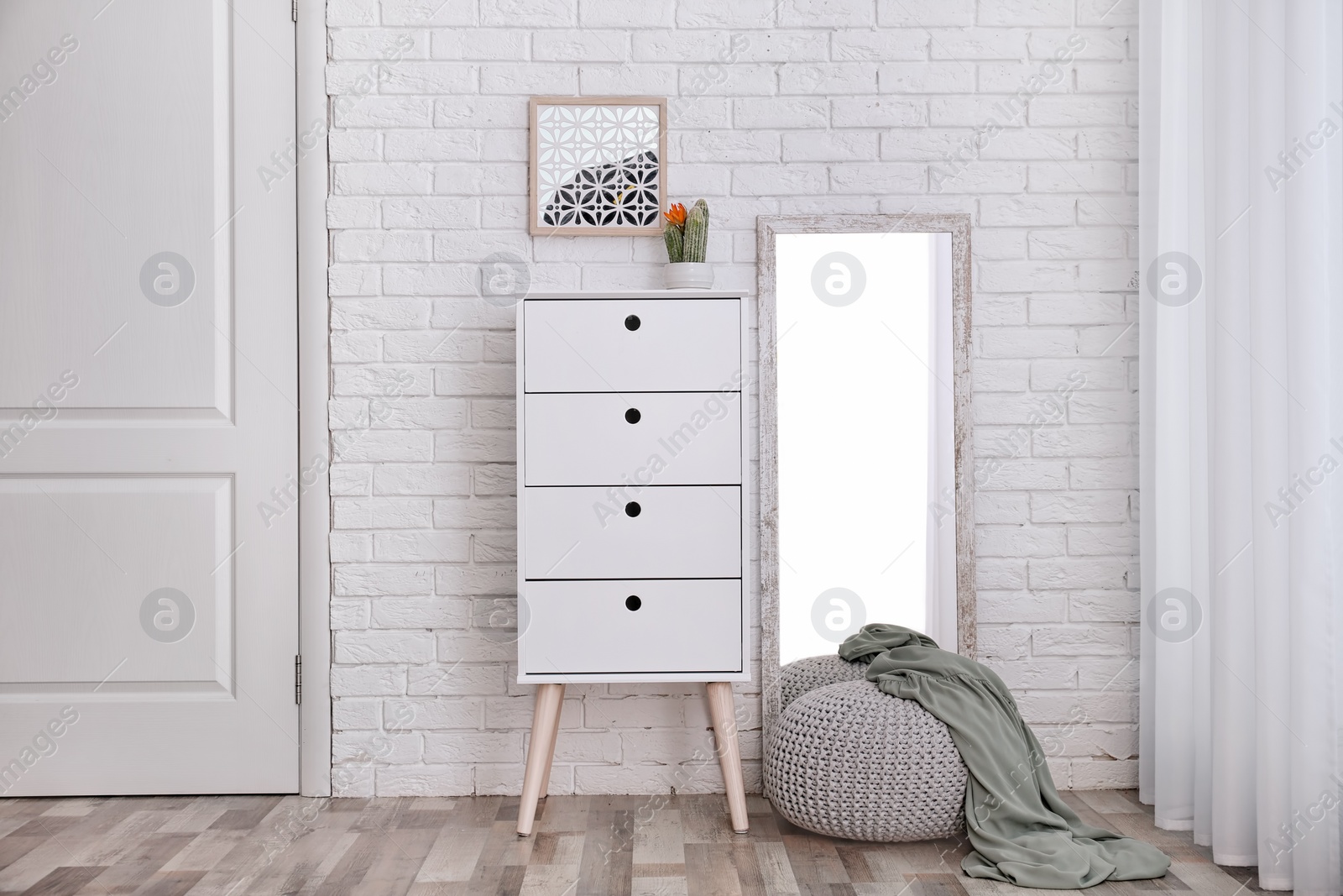 Photo of Modern room interior with large mirror and cabinet