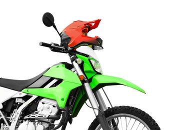 Stylish green cross motorcycle and helmet on white background, closeup