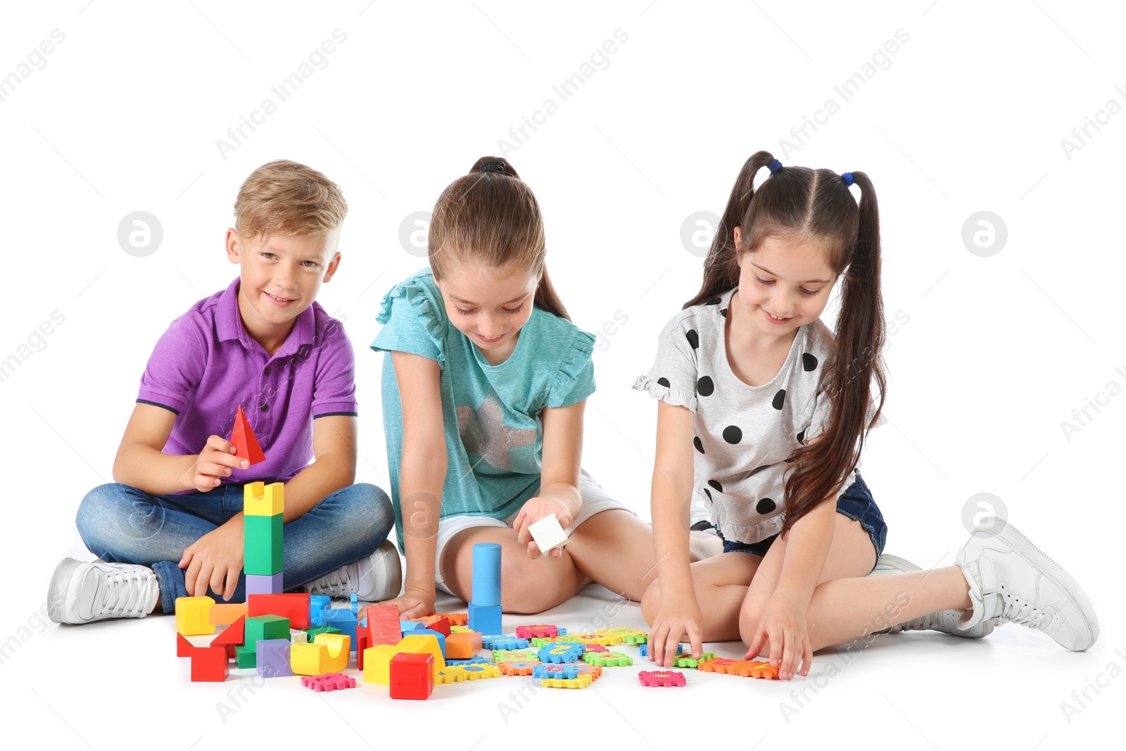 Photo of Little children playing together on white background. Indoor entertainment