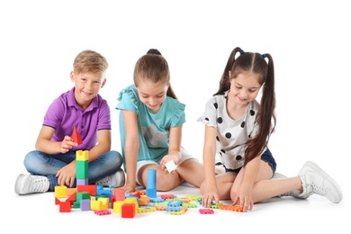 Photo of Little children playing together on white background. Indoor entertainment